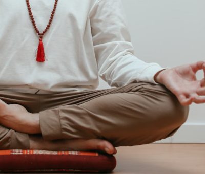 Close-up of a person meditating in a serene indoor setting, focusing on mindfulness.